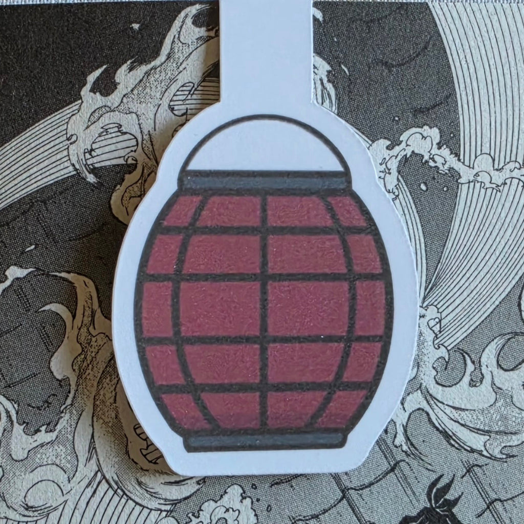 A magnetic bookmark featuring a red paper lantern illustration with black grid lines, placed on a gray and white manga illustration background.